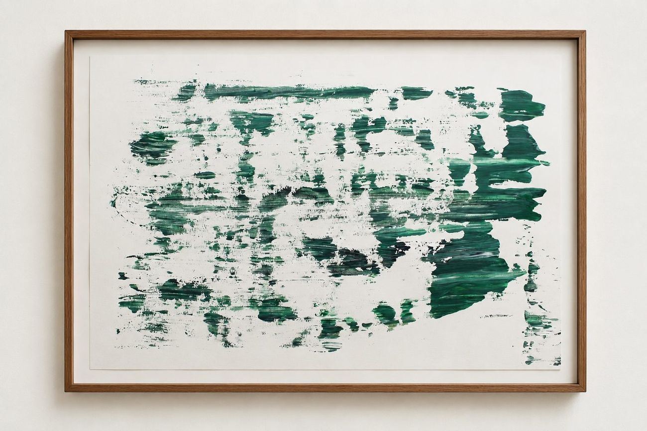 Green brushed marks scattered over white paper, in an oak frame