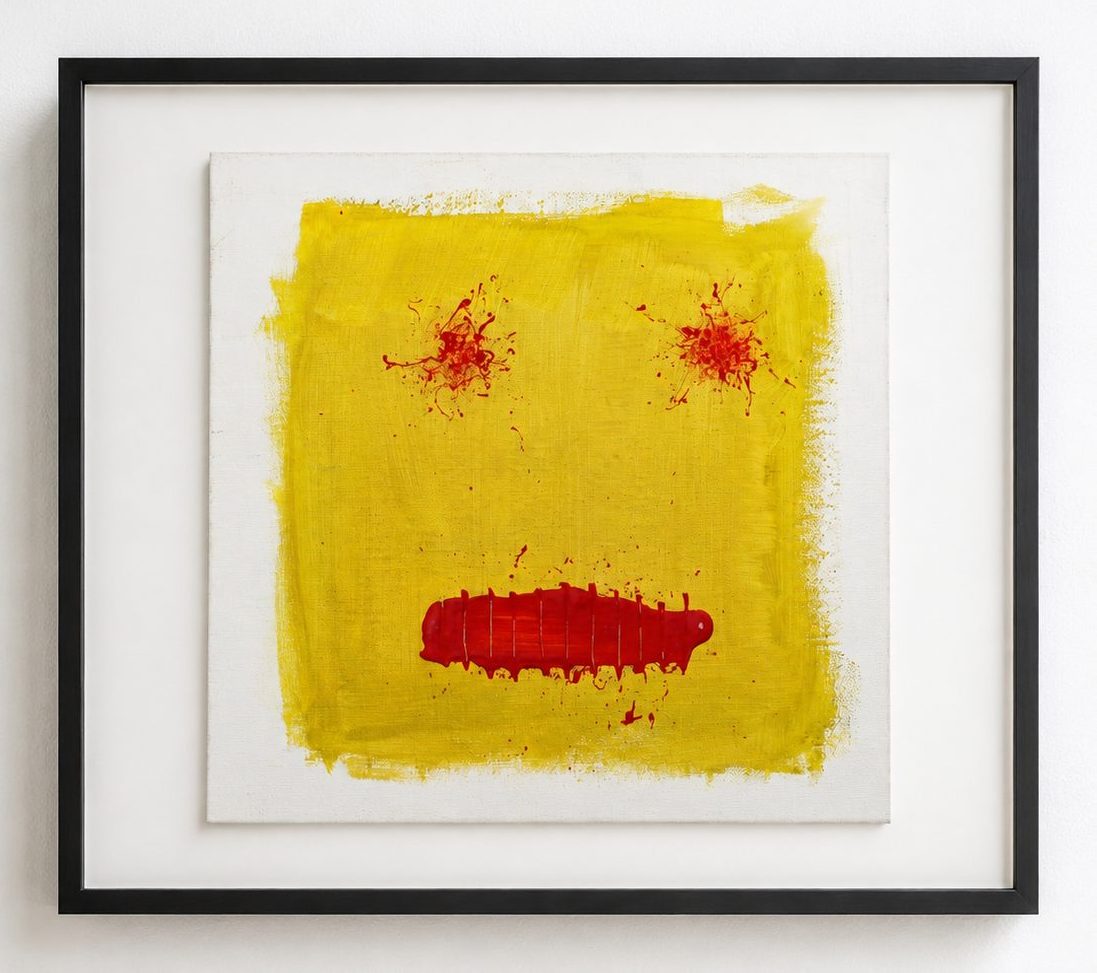 A yellow square with red eyes and a red mouth, in a black frame