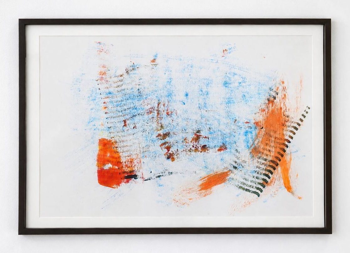 A pale drawing with blue and orange scribbles, in a dark frame