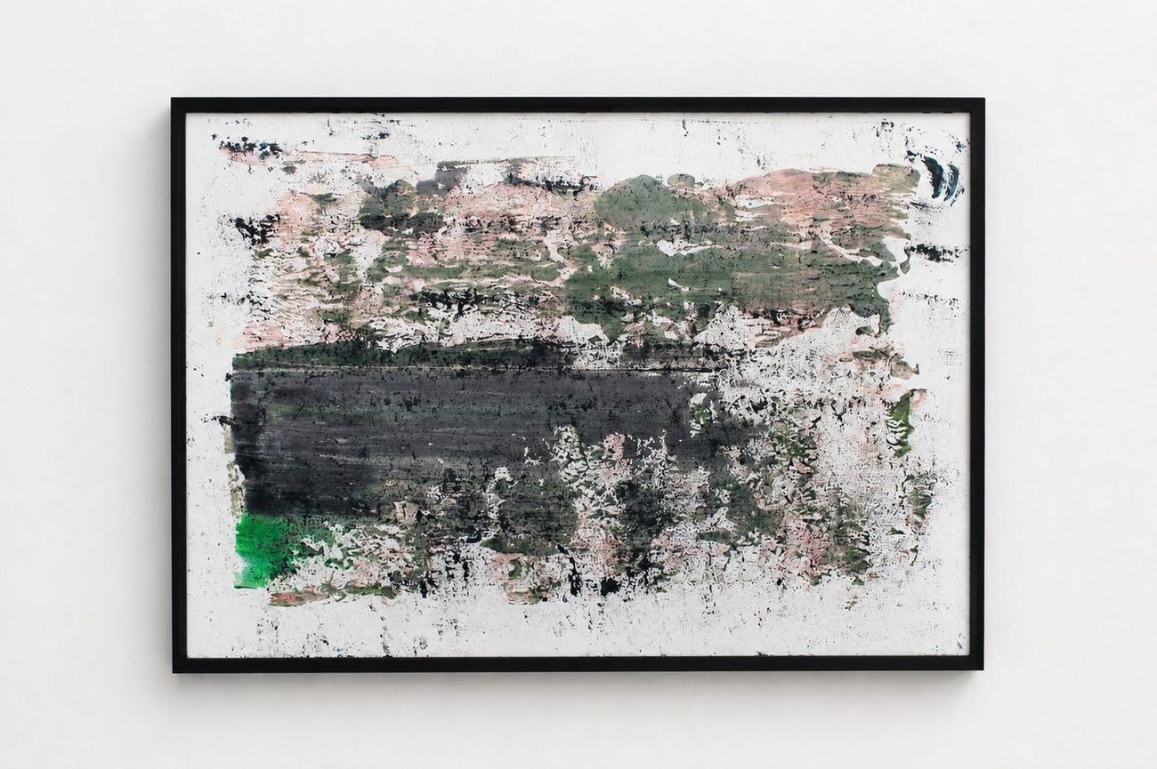 A white work on paper with a black band and green and pink marks, in a black frame