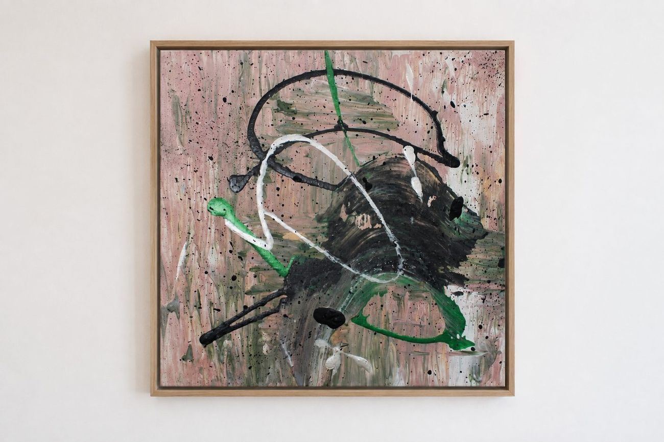 A pink and olive canvas with black, white and green loops, in an oak frame