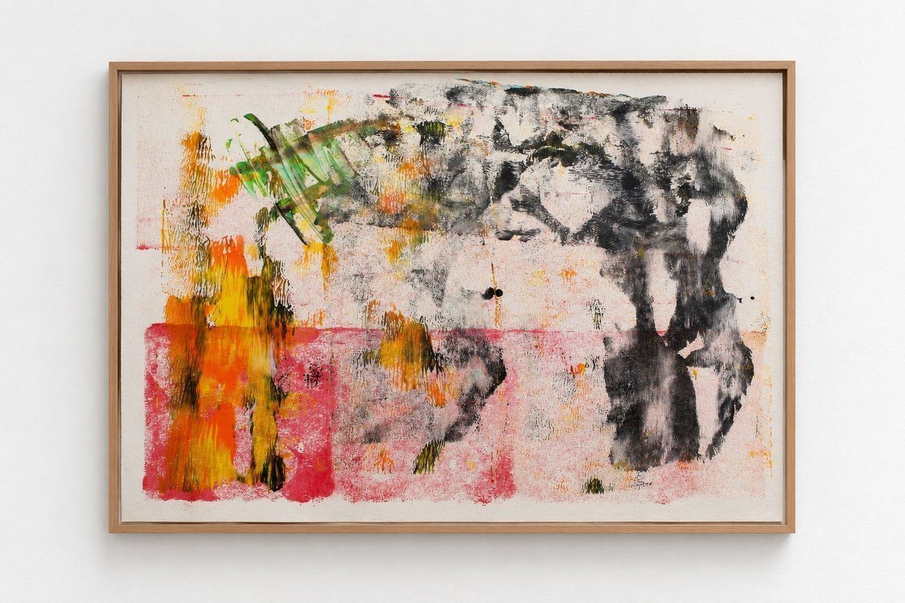 A pink and orange work on paper with black and green marks, in an oak frame