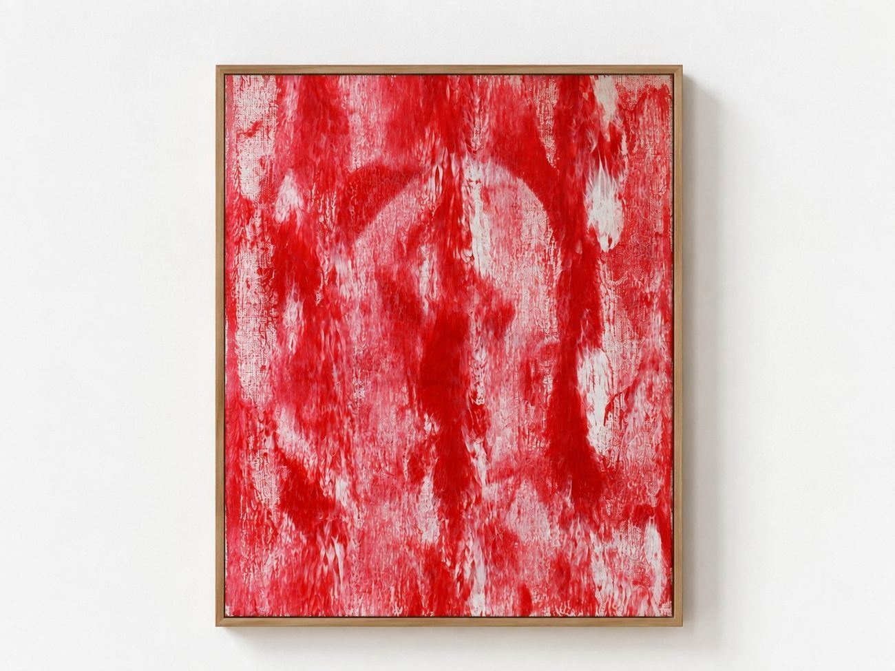 A red and white canvas with a scraped arc, in an oak frame