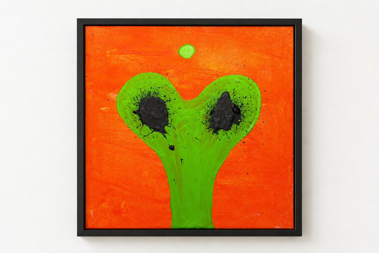 An orange canvas with a green Y-shape and two black blots, in a black frame