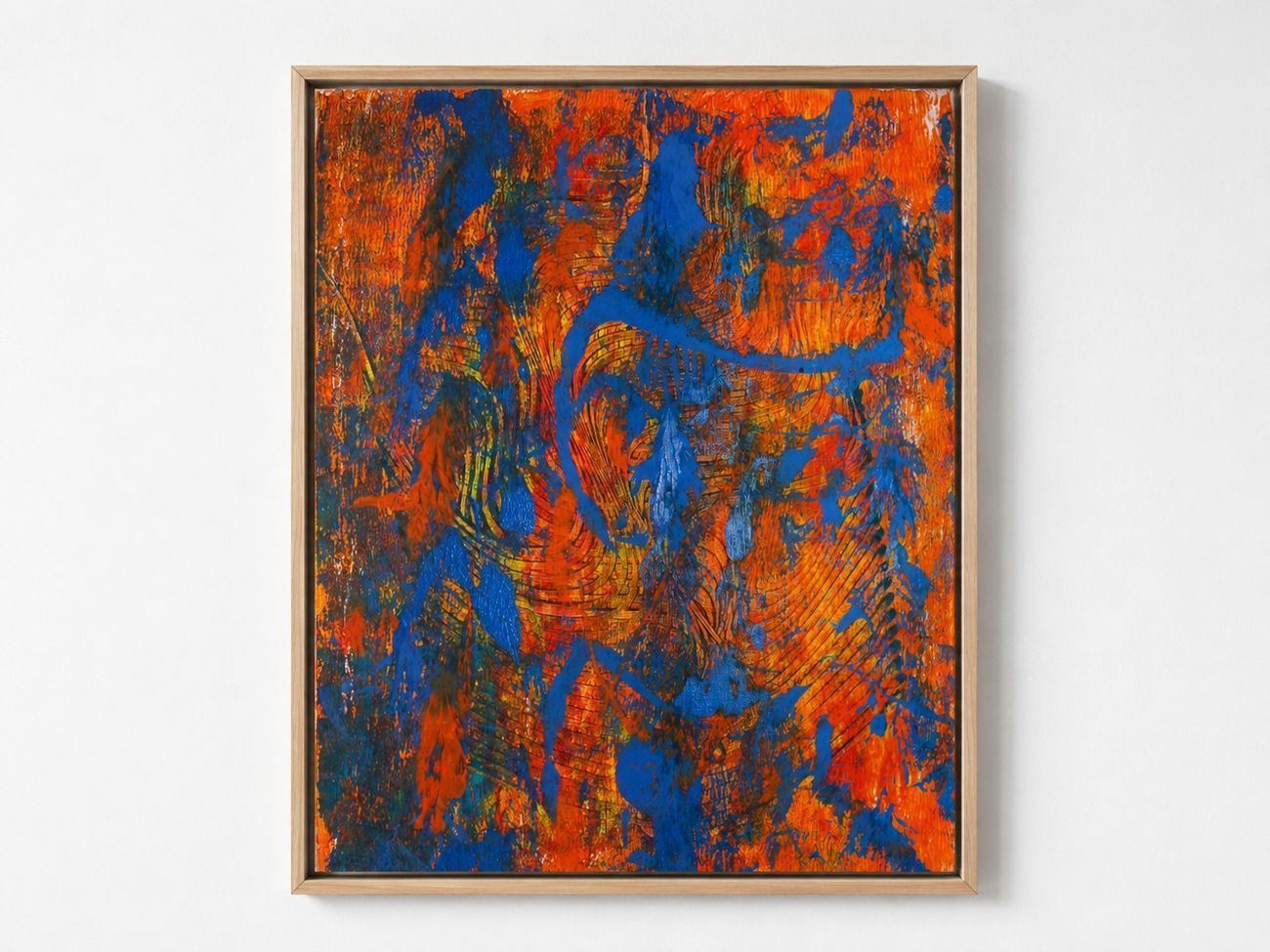 An orange canvas with heavy blue strokes, in an oak frame