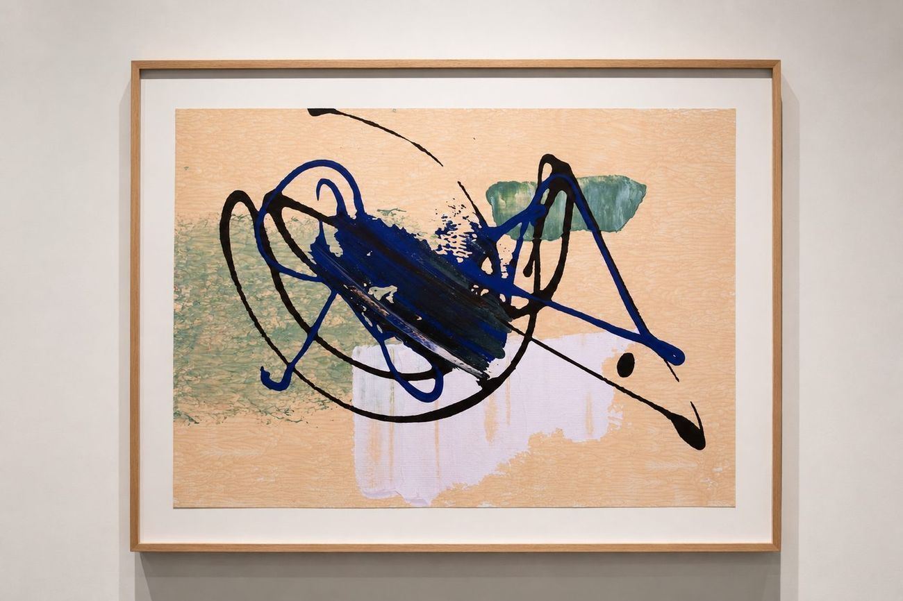 A peach work with dark blue and black loops, in an oak frame