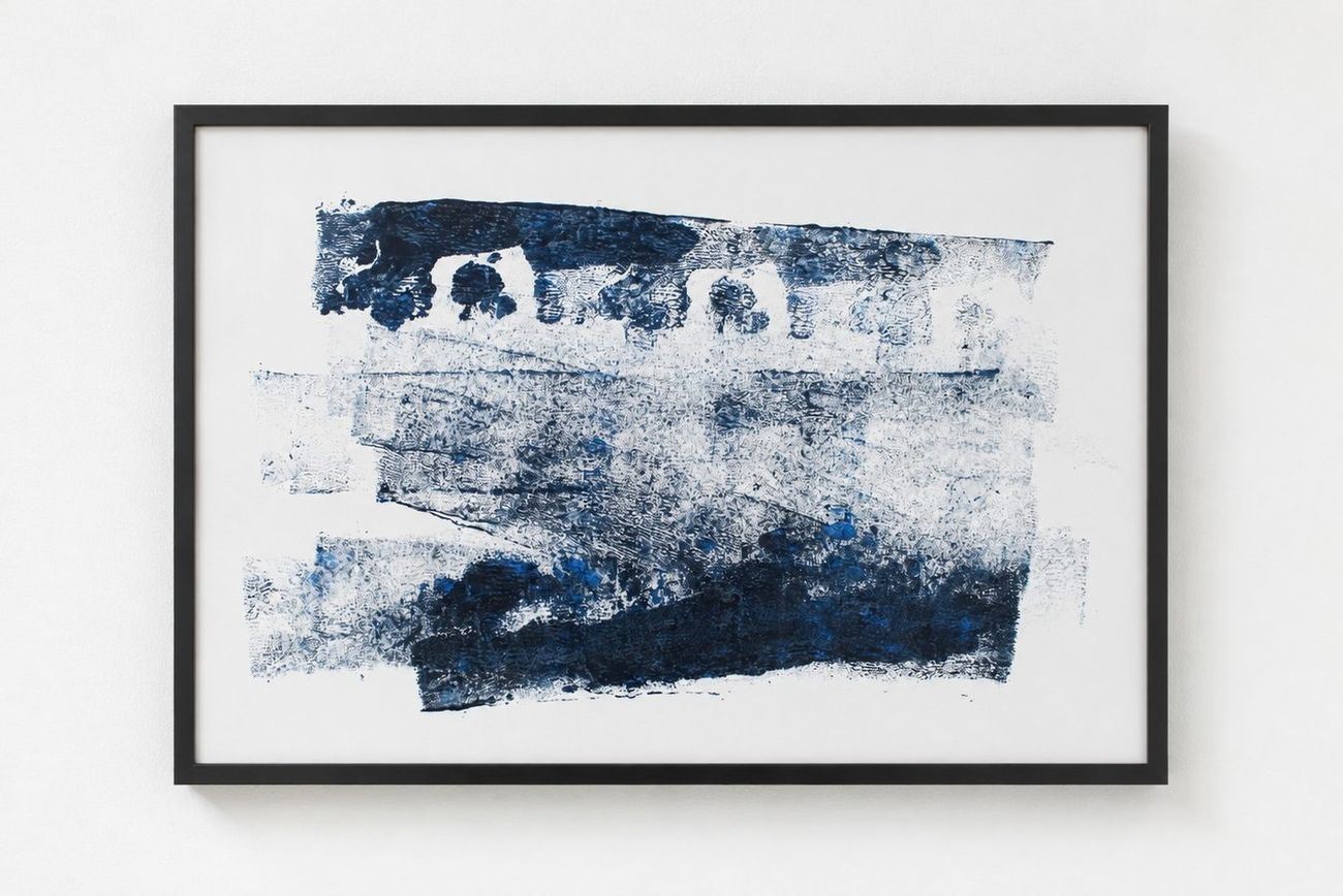 A navy monotype in layered bands, in a black frame