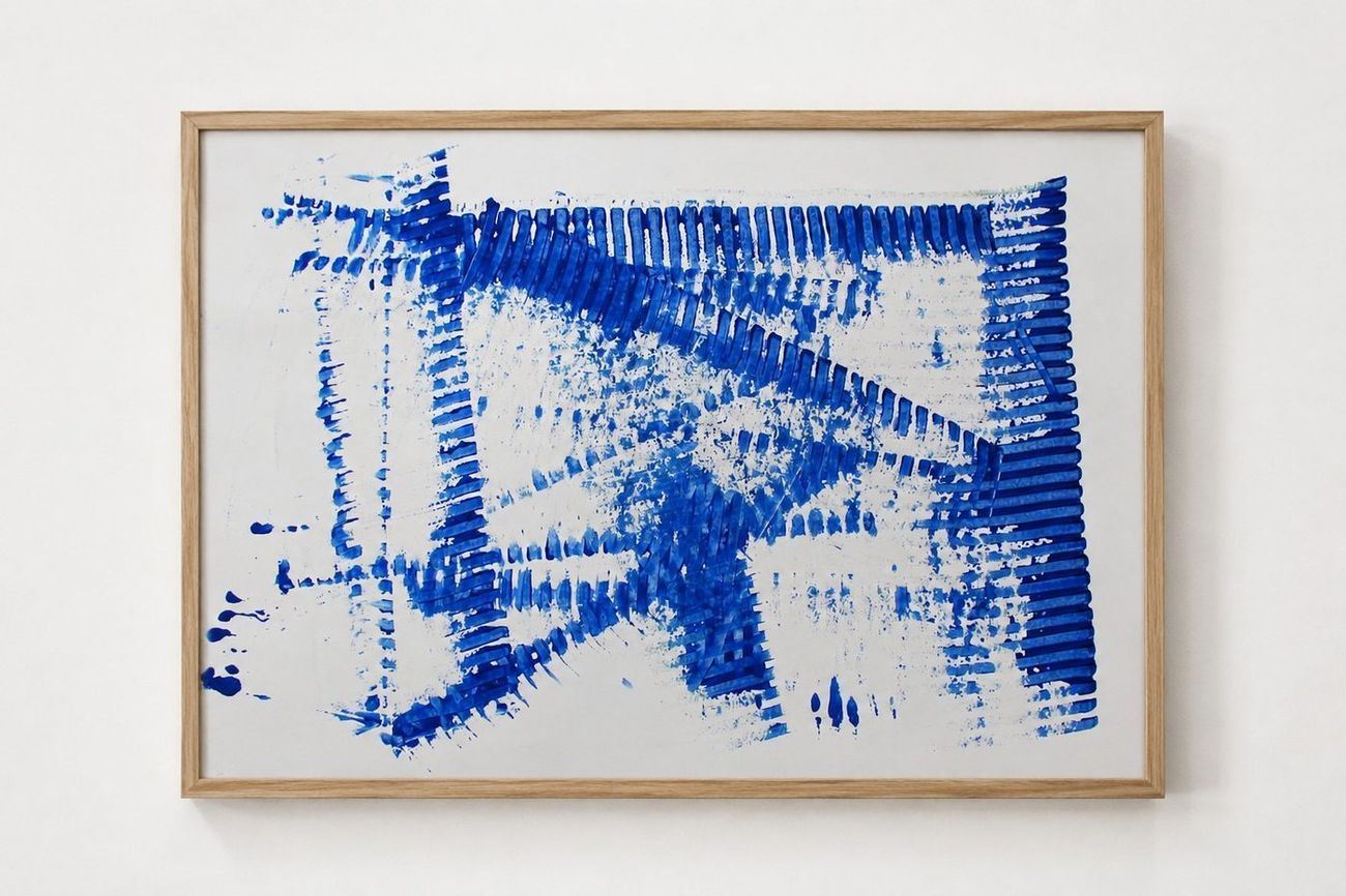 Blue combed strokes across white paper, in an oak frame